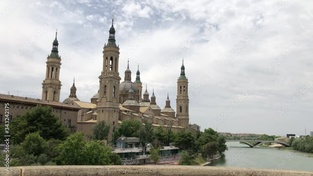 The Cathedral-Basilica of Our Lady of the Pillar, a Roman Catholic church in the city of Zaragoza, in Aragon, Spain, on river Ebro seen by the Old Stone bridge The Cathedral-Basilica of Our Lady of the Pillar, a Roman Catholic church in the city of Zaragoza, in Aragon, Spain, on river Ebro seen by the Old Stone bridge