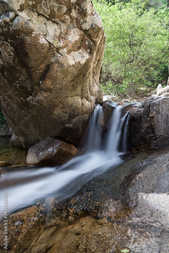 Fototapeta premium Small waterfall between rocks in Sardinia