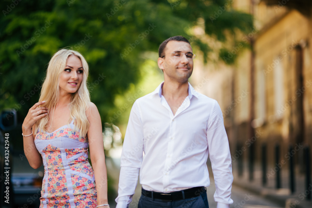 Fototapeta premium woman with her husband walking around the city, dressed neatly