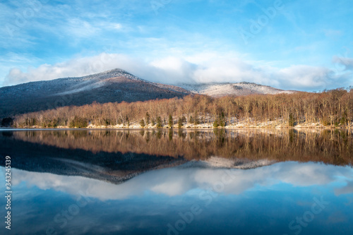 A bluebird morning view over a lake in the Adirondack Mountains. 