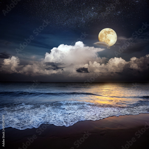 Sandy beach and moon at night