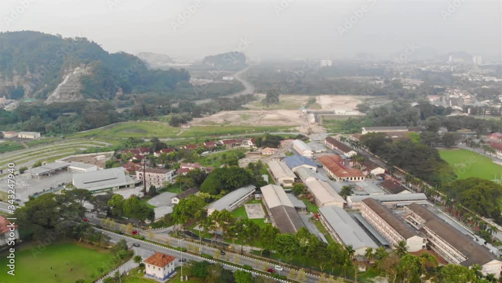 Busy roads with car passing by with a view of the misty morning hill and mountain near the city - slide left Busy roads with car passing by with a view of the misty morning hill and mountain near the city - slide left