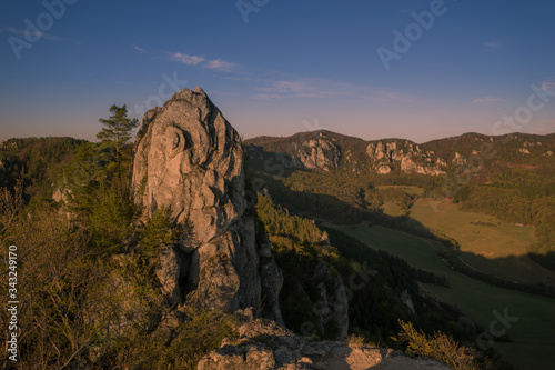 View of the countryside under the mountains at sunset.