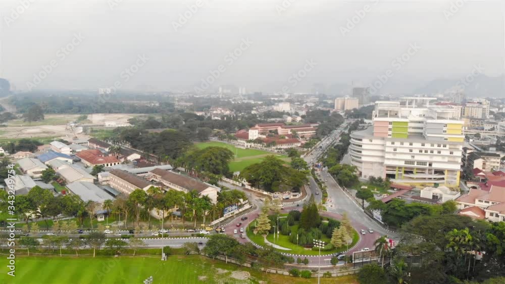 Morning fog in the city of Ipoh with car traffic on the road - Dolly Backwards Morning fog in the city of Ipoh with car traffic on the road - Dolly Backwards