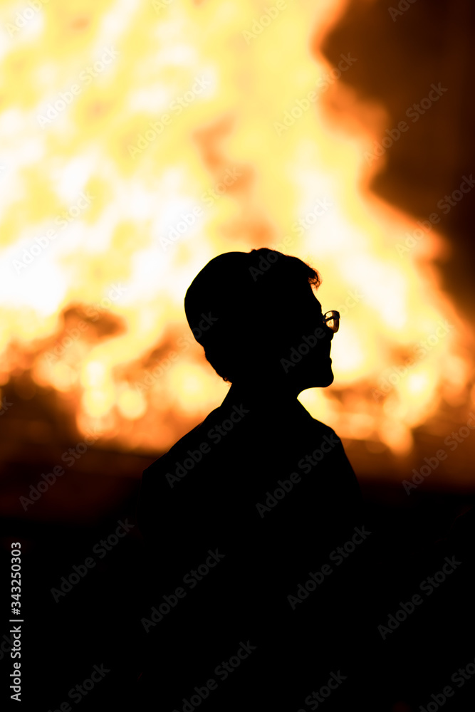 Silhouette of a child against a Lag Baomer bonfire, the Jewish holiday where large bonfires are lit and dancing around them, Silhouette of a child against a Lag Baomer bonfire, the Jewish holiday where large bonfires are lit and dancing around them,