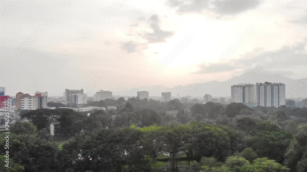 Town view from above with trees and silhouette of a mountain - Ascending Town view from above with trees and silhouette of a mountain - Ascending