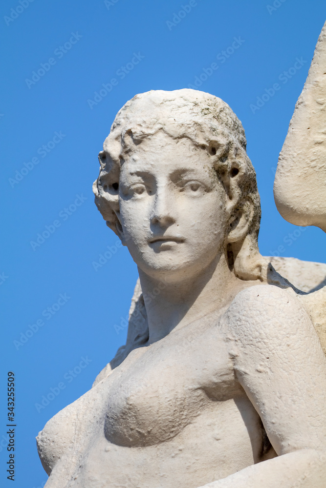 old sculpture of woman in bright sunlight