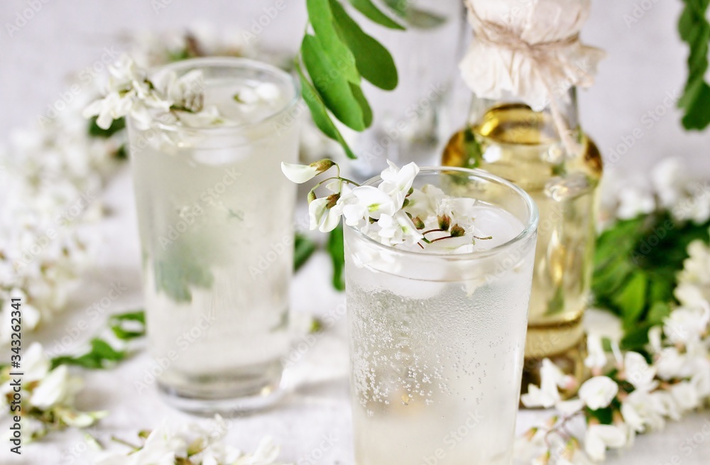 lemonade with a syrup of white acacia flowers. organic food from nature. natural habitat. Edible flowers.