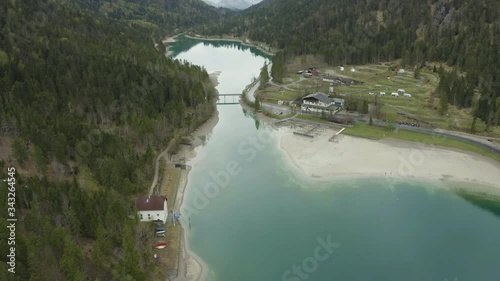 Wallpaper Mural The Improbable aerial landscape of lake, Italy, drone flies low over azure water of lake, an empty beach, cloudy weather, coastline, bridge Torontodigital.ca