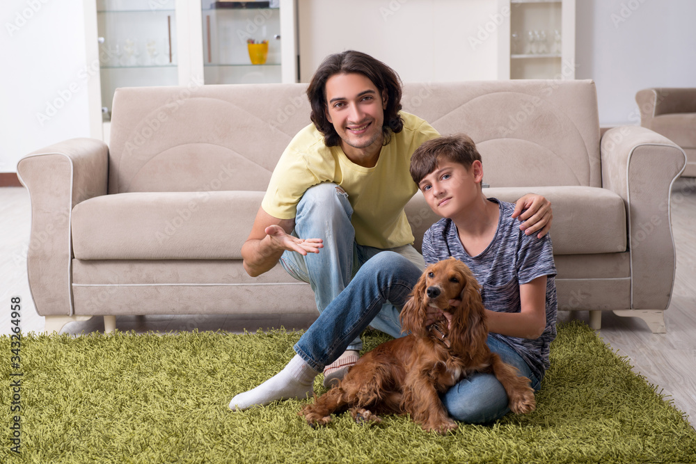 Young father and his son with cocker spaniel dog Young father and his son with cocker spaniel dog