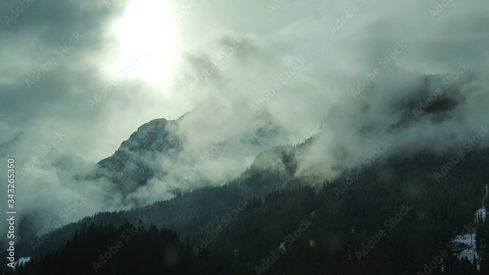 Scenic View Of Mountains Against Cloudy Sky