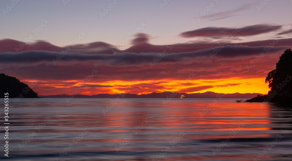 Dramatic sunrise at sea. Abel Tasman National Park, New Zealand