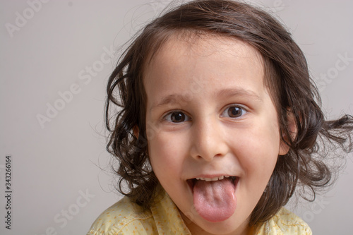 Little boy shows his tongue like Einstein