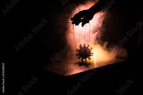 Coronavirus 2019-nCov novel coronavirus concept. Crowd looking on big Corona virus model at night with fog and backlight. Creative artwork decoration. Selective focus. photo