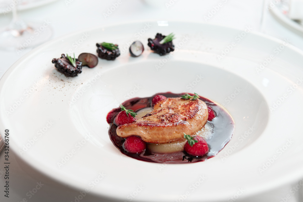 Foie gras with port sauce on white plate, haute cuisine Foie gras with port sauce on white plate, haute cuisine