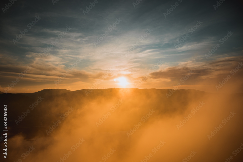 Orange sunset view at mountains in Azerbaijan. Cloudy weather.