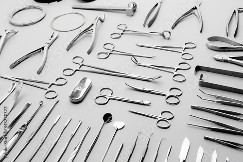 Close-up medical instruments, laid out on a gray background photo