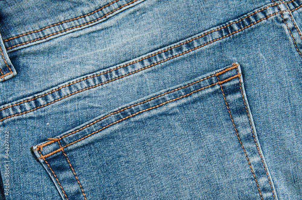 Denim pants in blue on a wooden background Denim pants in blue on a wooden background