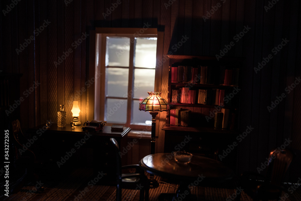 A realistic dollhouse living room with furniture and window at night. Artwork table decoration with handmade realistic dollhouse.