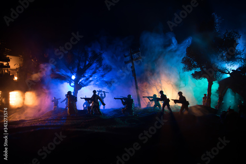 War Concept. Military silhouettes fighting scene on war fog sky background, World War Soldiers Silhouette Below Cloudy Skyline At night.