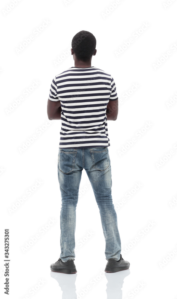 rear view. a young man reading something on a white wall rear view. a young man reading something on a white wall
