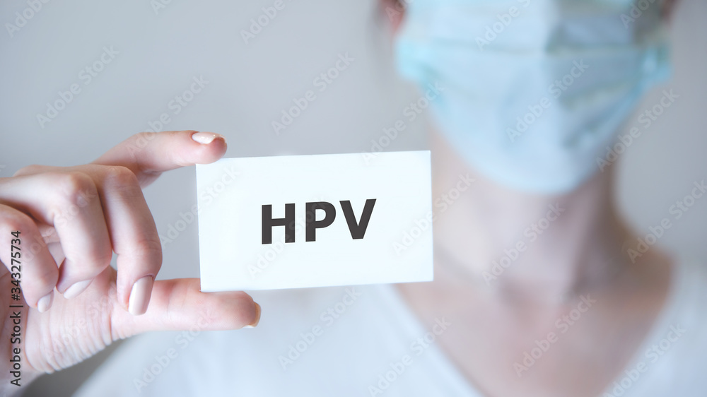 a doctor showing a signboard with the word HPV written in it a doctor showing a signboard with the word HPV written in it
