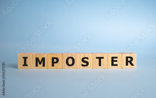concept word imposter on cubes on a blue background.