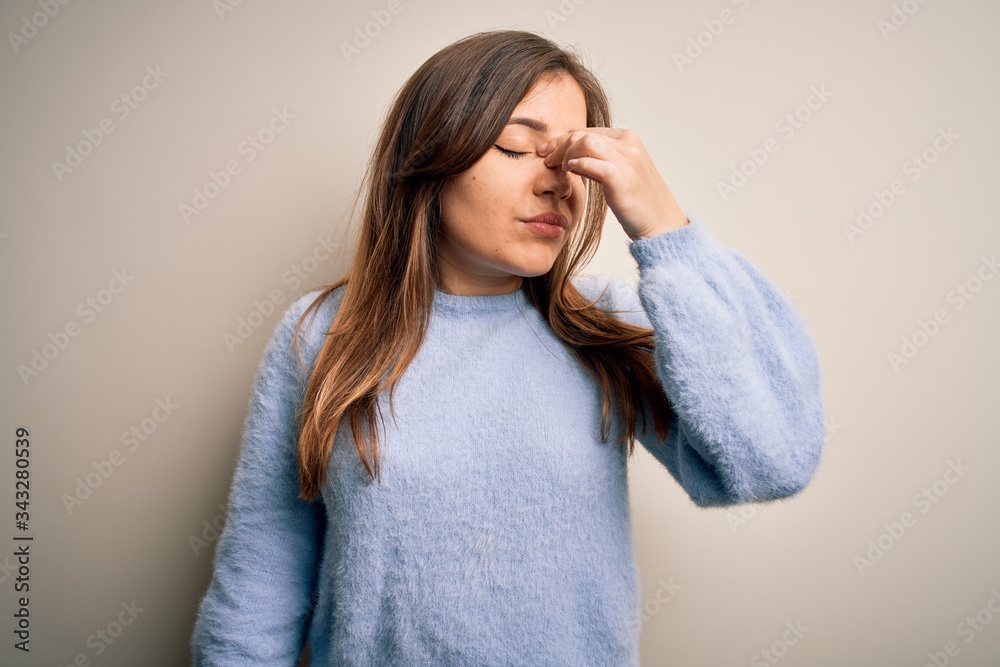 Beautiful young woman wearing casual winter sweater standing over isolated background tired rubbing nose and eyes feeling fatigue and headache. Stress and frustration concept. Beautiful young woman wearing casual winter sweater standing over isolated background tired rubbing nose and eyes feeling fatigue and headache. Stress and frustration concept.