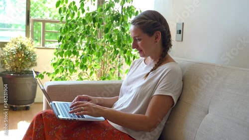 Young woman working at home on a laptop during coronavirus quarantine