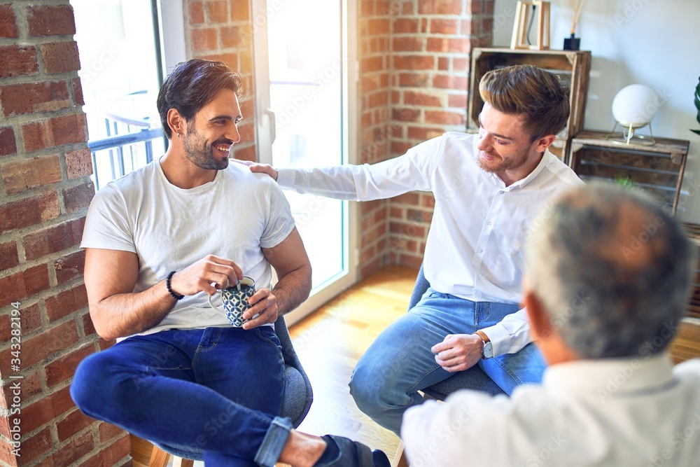 Fototapeta premium Handsome businessmen smiling happy. Sitting with smile on face speaking taking rest at the office