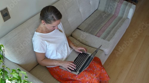 Young woman working at home on a laptop during coronavirus quarantine