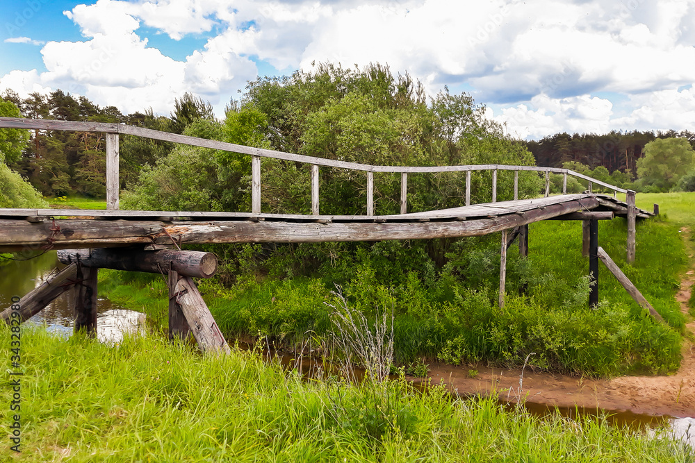 Old wooden bridge over a small river