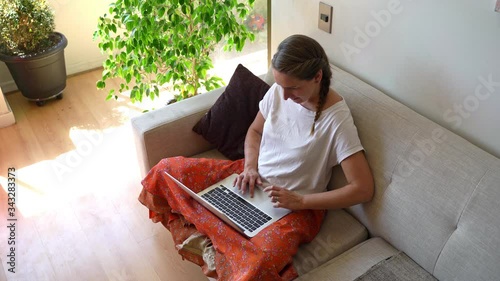 Young woman working at home on a laptop during coronavirus quarantine