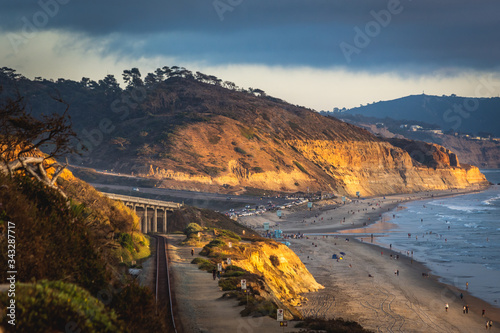 Sunset image of Torrey pine trees with a bridge and railroad tracks