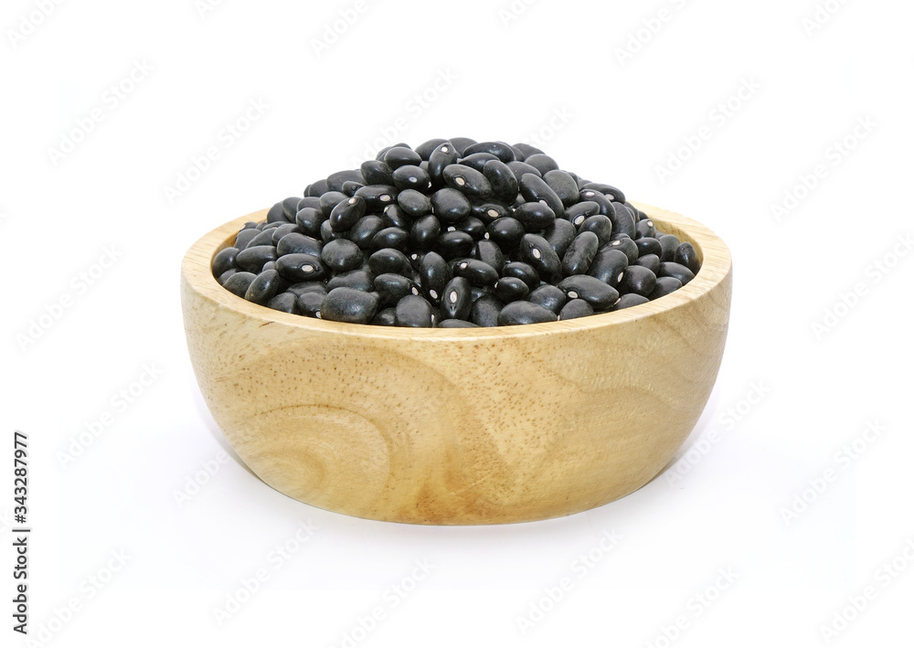 Black turtle bean (Black bean) in wooden bowl isolated on white background. In Traditional Chinese Medicine black beans are known for their ability to tonify blood and yin, also regulate water. Black turtle bean (Black bean) in wooden bowl isolated on white background. In Traditional Chinese Medicine black beans are known for their ability to tonify blood and yin, also regulate water.