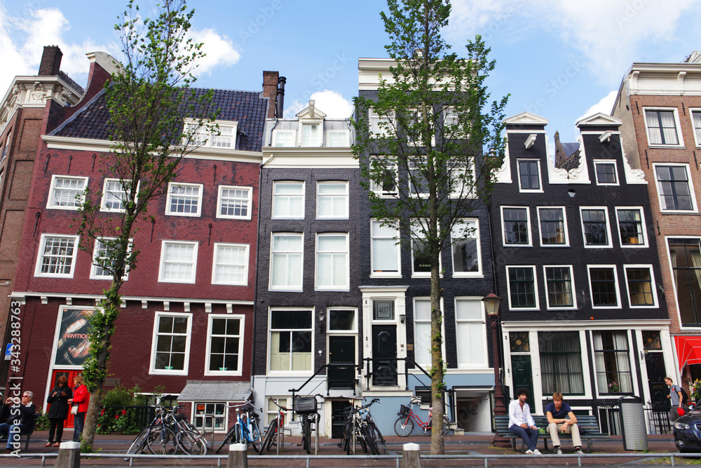 Amsterdam canals and typical houses with clear spring sky