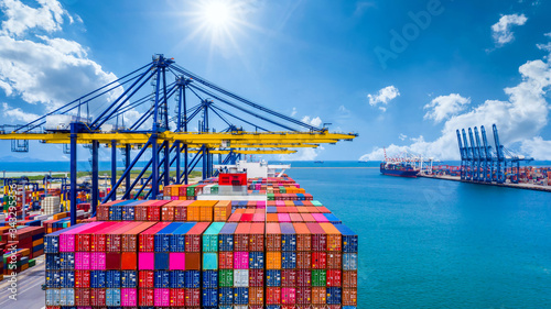 Container ship unloading in deep sea port, Global business logistic import export freight shipping transportation oversea worldwide by container ship open sea, Container vessel loading cargo freight. photo