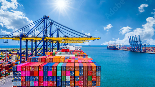 Container ship unloading in deep sea port, Global business logistic import export freight shipping transportation oversea worldwide by container ship open sea, Container vessel loading cargo freight.