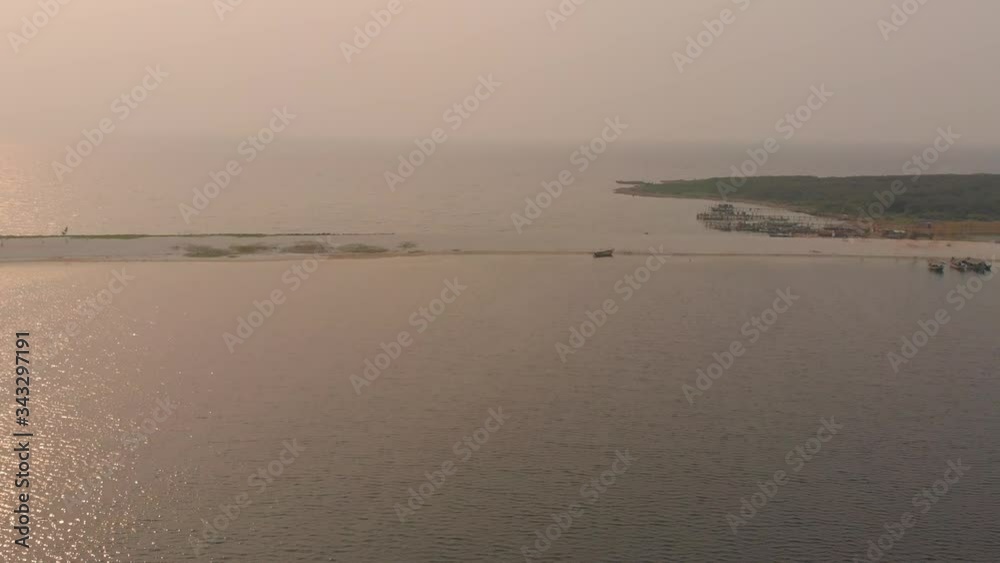 Aerial descending on Ancol Beach horizon during sunset in Jakarta, capital of Indonesia Aerial descending on Ancol Beach horizon during sunset in Jakarta, capital of Indonesia