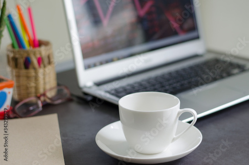 Coffee mugs and laptops on work desk at home  during the quarantine to prevent the Covid-19 virus