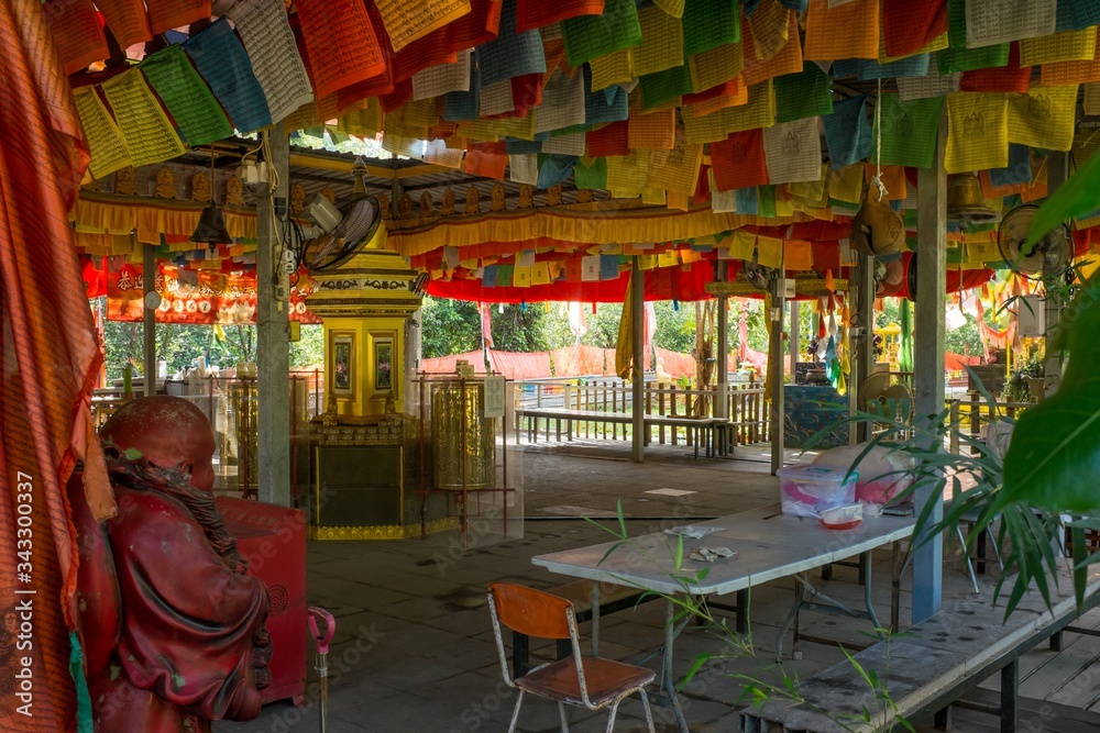 Interior of Wei Tuo Fa Gong Buddhist Temple Hall with Prayer Flags on Tropical Pulau Ubin Island, Singapore Interior of Wei Tuo Fa Gong Buddhist Temple Hall with Prayer Flags on Tropical Pulau Ubin Island, Singapore