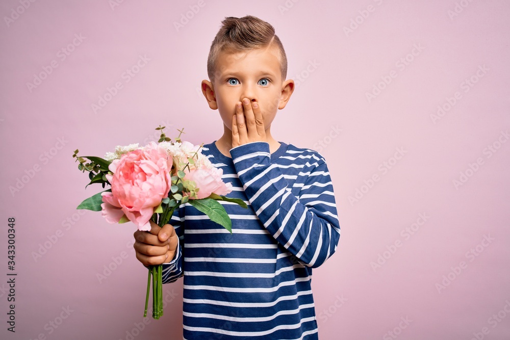 Young little caucasian kid holding romantic and cute bouquet of flowers over pink background cover mouth with hand shocked with shame for mistake, expression of fear, scared in silence, secret concept Young little caucasian kid holding romantic and cute bouquet of flowers over pink background cover mouth with hand shocked with shame for mistake, expression of fear, scared in silence, secret concept