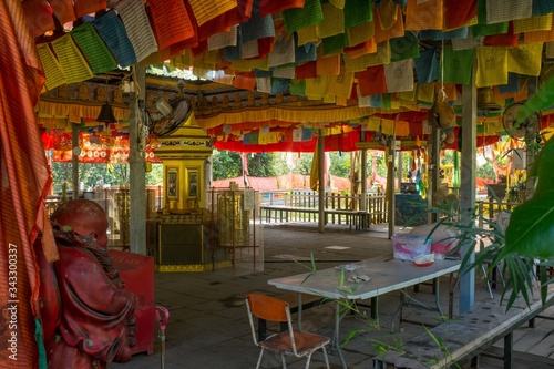 Interior of Wei Tuo Fa Gong Buddhist Temple Hall with Prayer Flags on Tropical Pulau Ubin Island, Singapore