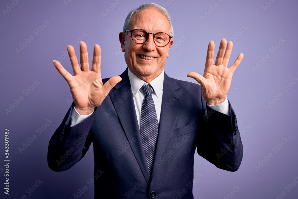 Grey haired senior business man wearing glasses and elegant suit and tie over purple background showing and pointing up with fingers number ten while smiling confident and happy. Grey haired senior business man wearing glasses and elegant suit and tie over purple background showing and pointing up with fingers number ten while smiling confident and happy.