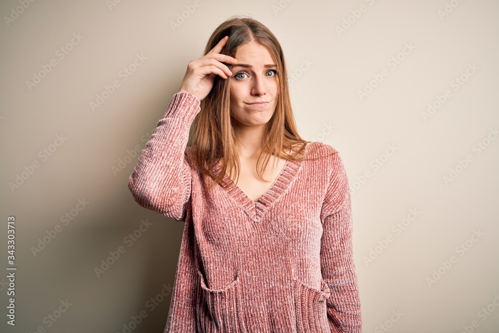 Young beautiful redhead woman wearing pink casual sweater over isolated white background worried and stressed about a problem with hand on forehead, nervous and anxious for crisis Young beautiful redhead woman wearing pink casual sweater over isolated white background worried and stressed about a problem with hand on forehead, nervous and anxious for crisis