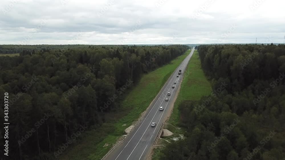 4K aerial summer cloudy day high quality video footage of forest gravel roads and federal highway connecting Moscow and Yaroslavl in Moscow region of Russia 4K aerial summer cloudy day high quality video footage of forest gravel roads and federal highway connecting Moscow and Yaroslavl in Moscow region of Russia