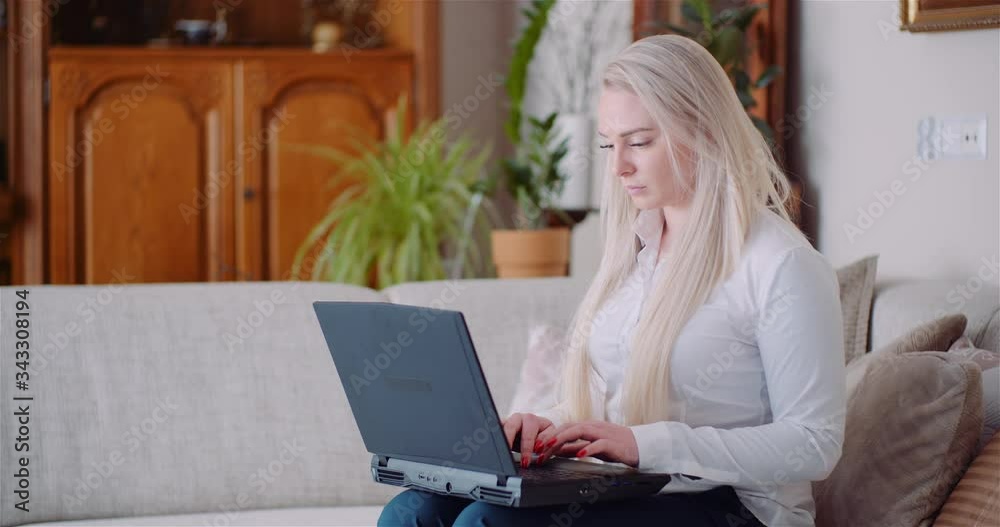 Businesswoman Working on Laptop on a Project at Home Office. Young Woman Using Laptop Computer at Home. Businesswoman Working on Laptop on a Project at Home Office. Young Woman Using Laptop Computer at Home.
