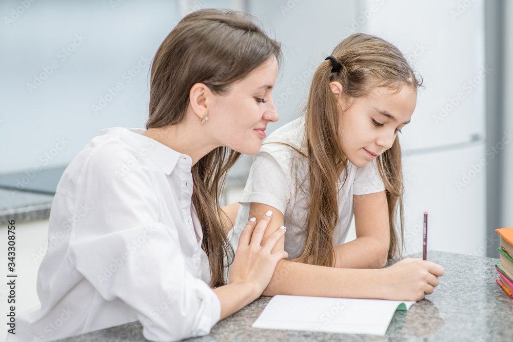 Mother and her daughter doing homework at home together Mother and her daughter doing homework at home together