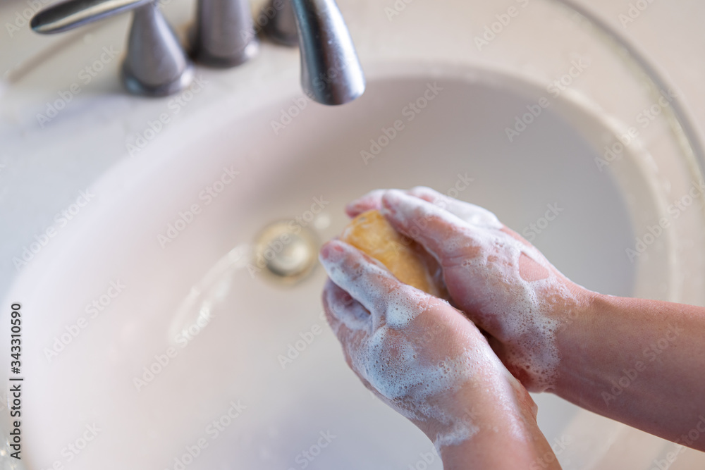 Fototapeta premium washing hands with soap,Coronavirus pandemic prevention wash hands with soap warm water and , rubbing nails and fingers washing frequently or using hand sanitizer gel.