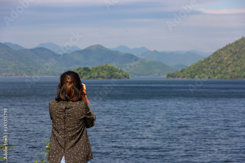 Asian woman tourist take a photo landscape of mountain and blue sky